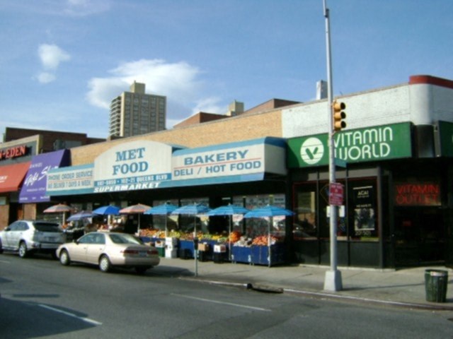 A street view of a bakery and a met food store.