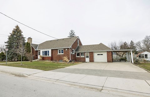 A house with a garage and a driveway in front.