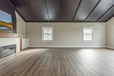 A room with a fireplace and a painting on the wall.