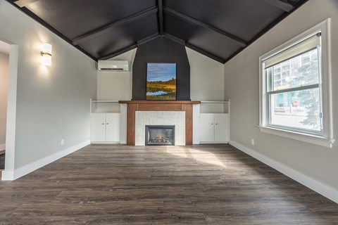 A room with a fireplace and a painting on the wall.
