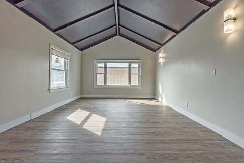 A room with wooden floors and a window.
