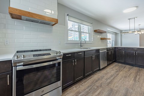 A kitchen with a stove top oven and a range hood.