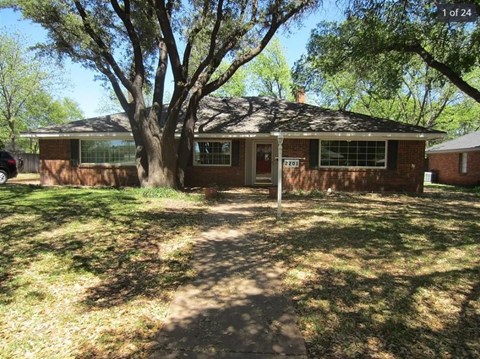 A house with a tree in front of it.