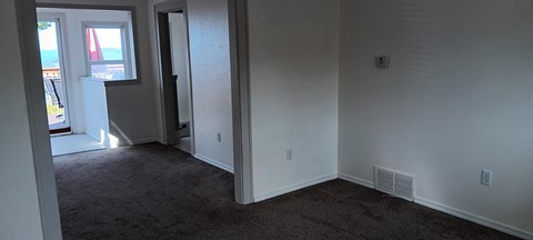 A room with a carpet floor and a window.