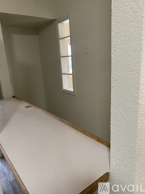 A room with a window and a bed.