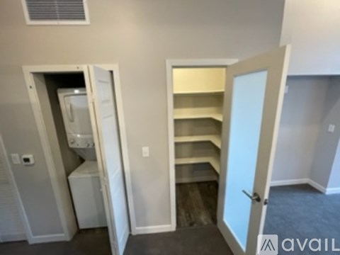 A kitchen area with a refrigerator and a pantry.