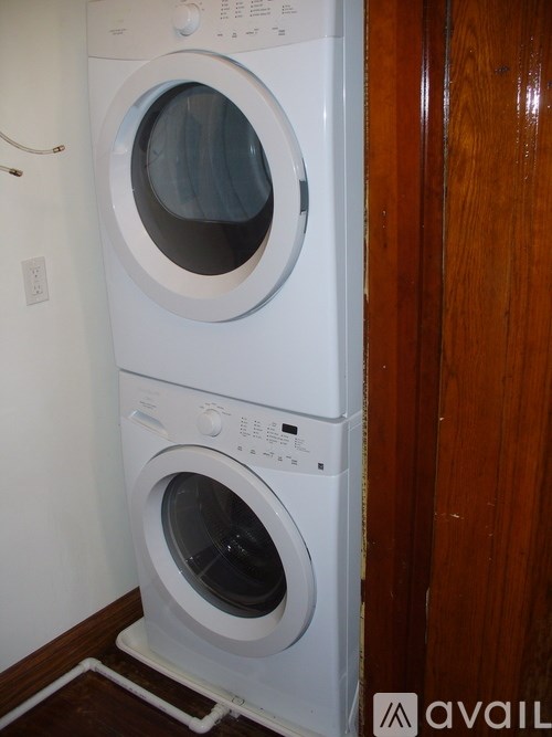 A white washing machine and dryer in a small room.