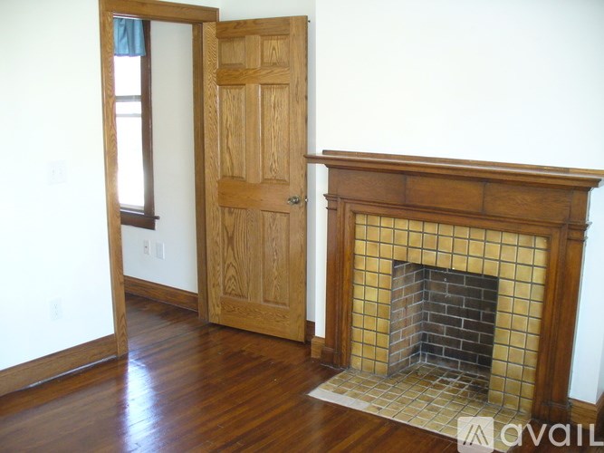 A room with a fireplace and a wooden door.
