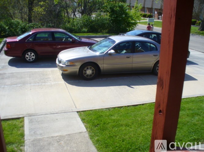 Two cars parked in a driveway.