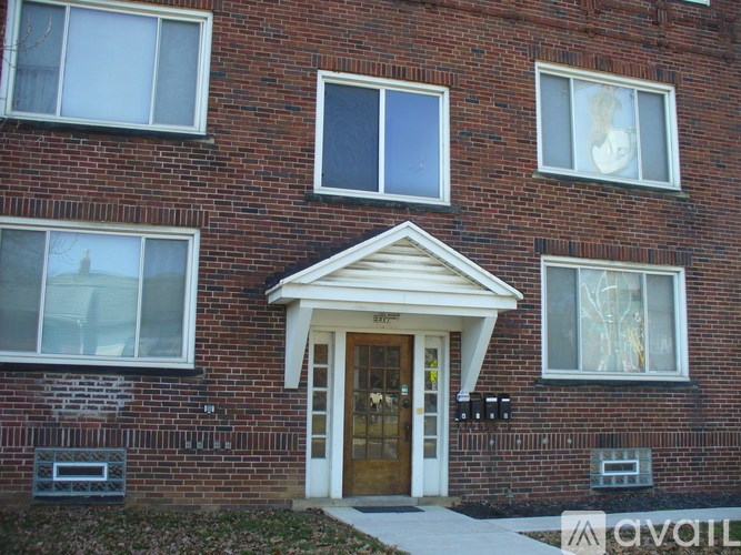 A brick building with a white door and windows.