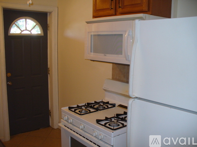 A white stove and refrigerator in a kitchen.