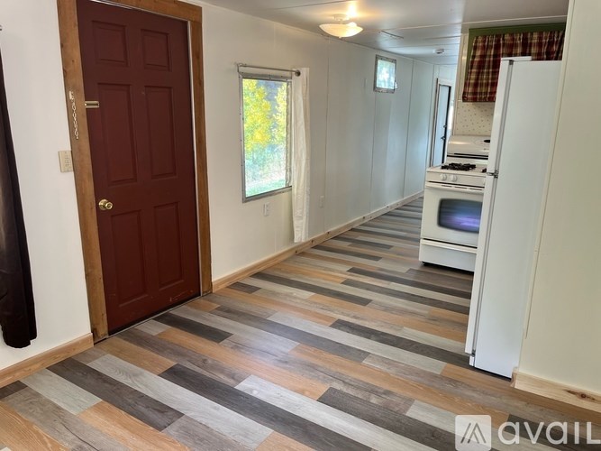 A kitchen area with a refrigerator, microwave, and oven.