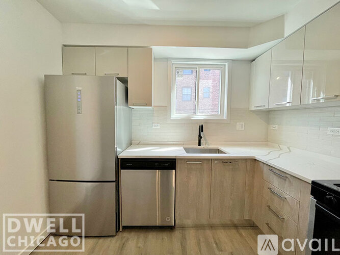 A kitchen with a stove, oven, microwave, and refrigerator.
