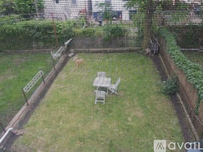 A small white airplane is parked in a grassy field.
