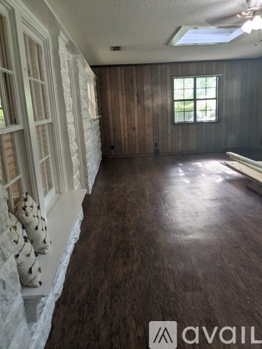 A room with wooden walls and a window.