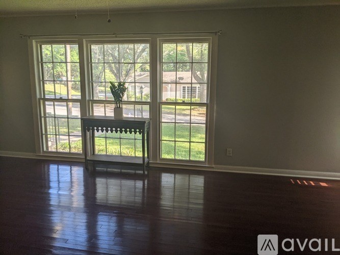 A room with a sliding glass door leading to a backyard.