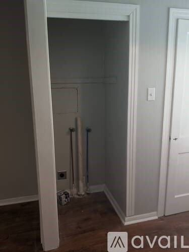 A room with a white door and a white wall.