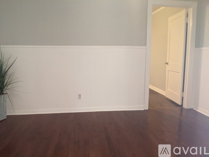 A room with a wooden floor and a door.