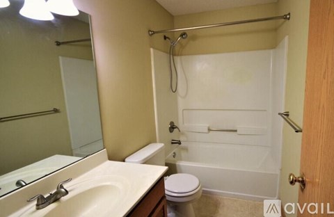 A bathroom with a toilet, sink, and bathtub.