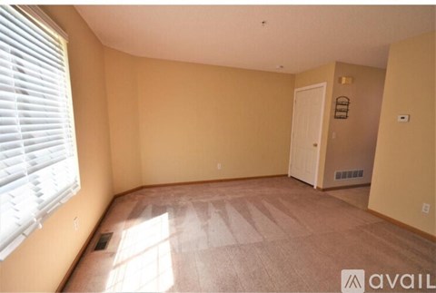 A room with beige walls and a carpeted floor.