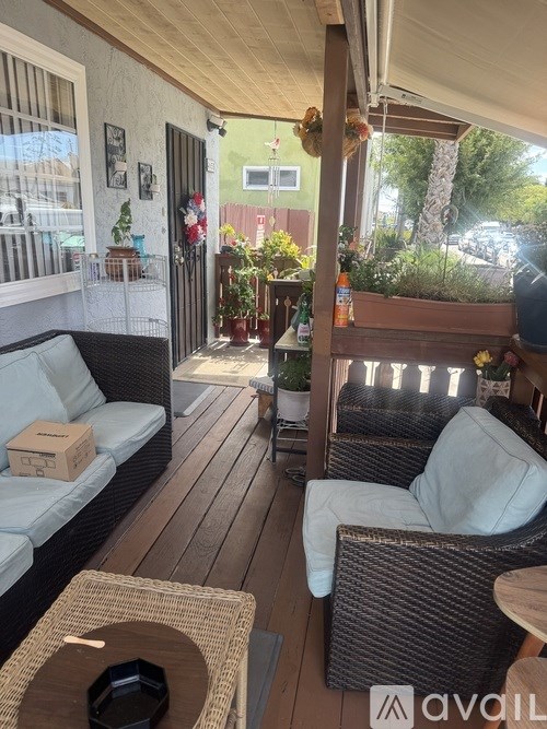 A patio with a couch, chairs, and a coffee table.