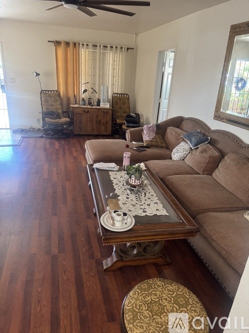 A living room with a brown couch and a coffee table.