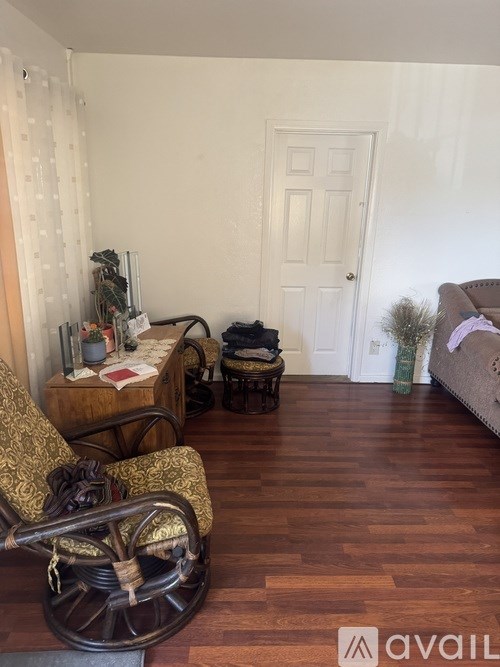 A room with a wooden floor and a white door.