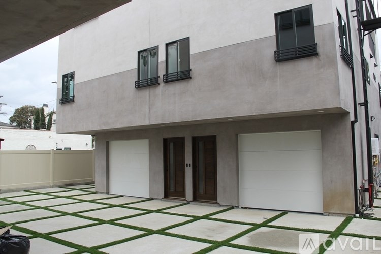 A modern house with a white garage door and black shutters.