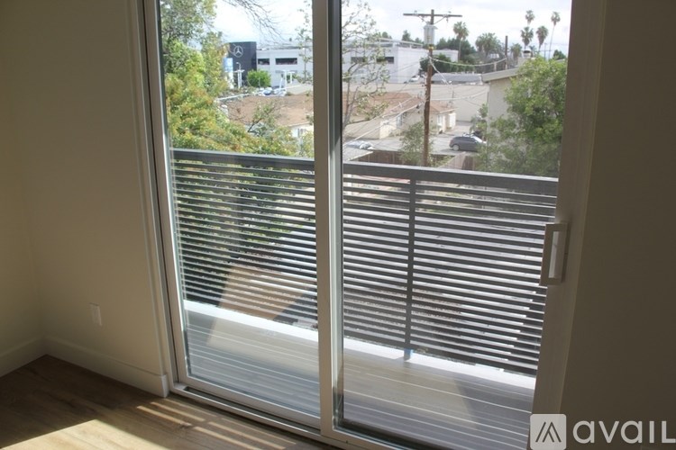 A view of a cityscape through a sliding glass door.