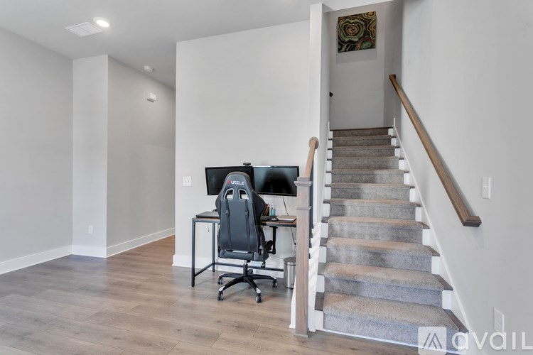 A home office with a staircase leading to the upper floor.