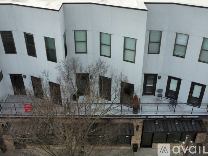 A white building with black windows and a balcony.