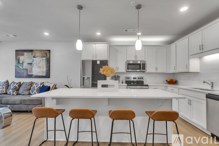 A modern kitchen with white cabinets and a large island.