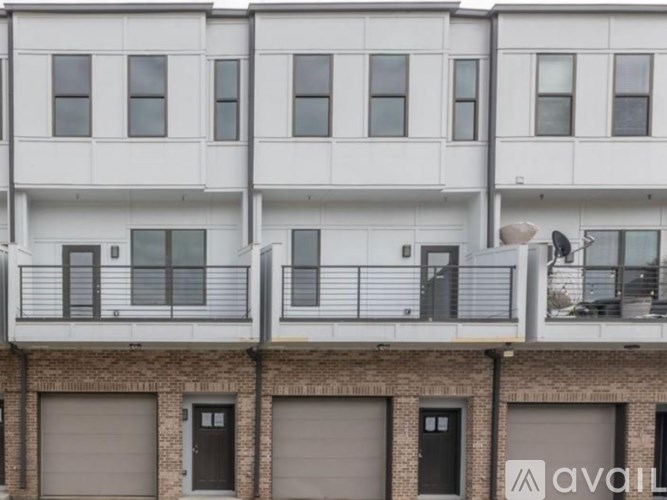 A white apartment building with black doors and windows.