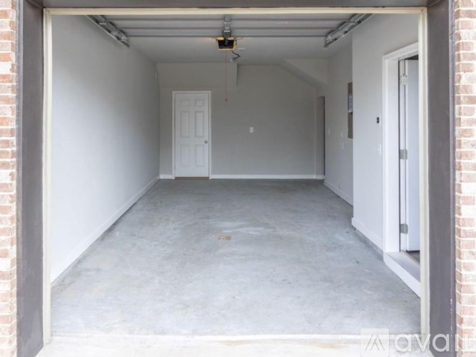 A white door is in the middle of a garage.