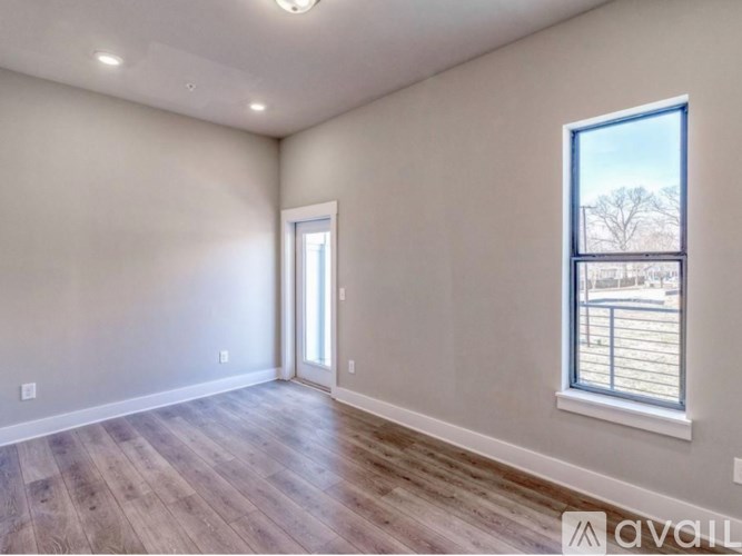 A room with a window and a door is available for rent.