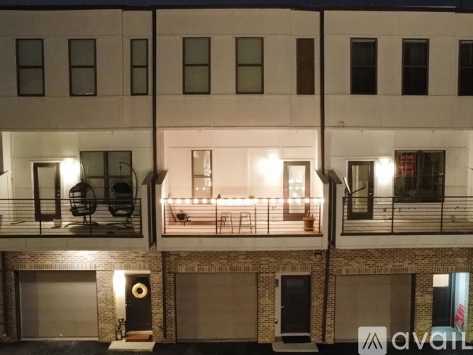 A building with a balcony and a speaker on the ground floor.