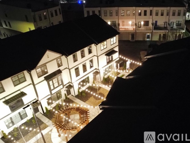 A building with a spiral staircase lit up at night.