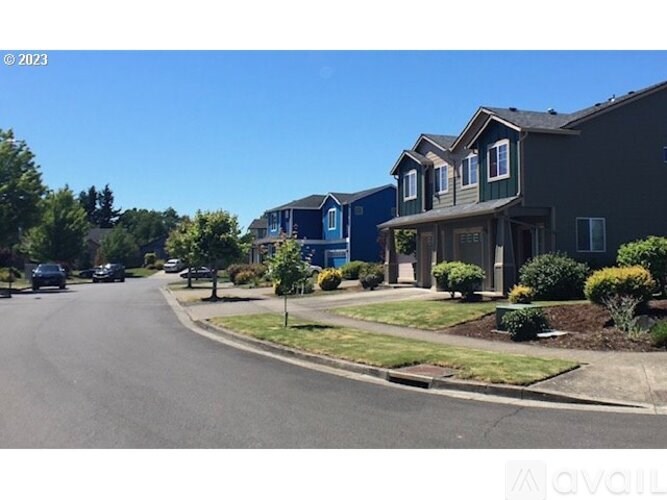 A street view of a residential area with houses on both sides.