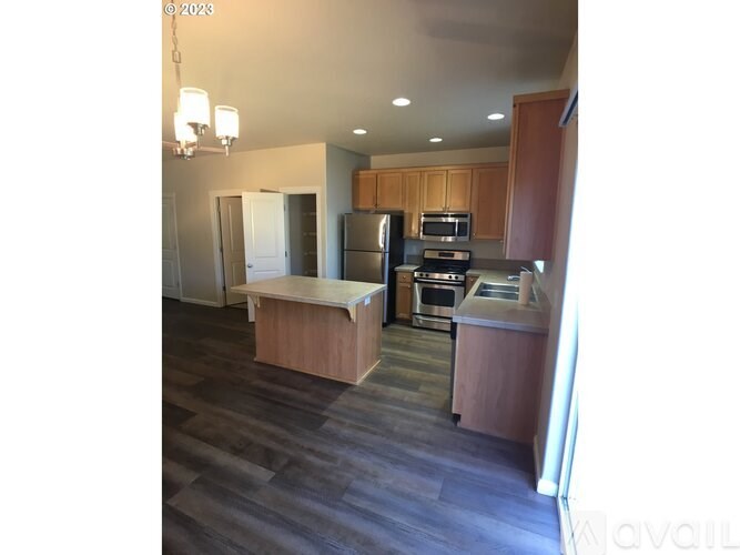 A kitchen with wooden cabinets and a countertop.
