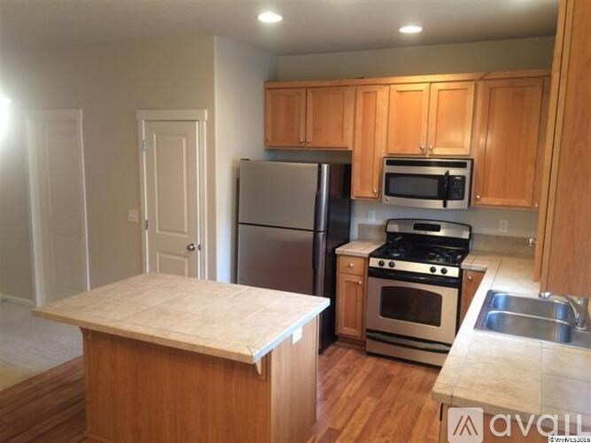 A kitchen with wooden cabinets and stainless steel appliances.