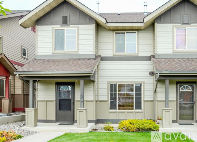 A two-story house with a grey and beige exterior.