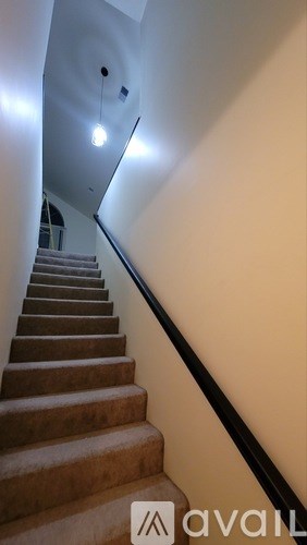 A staircase with a light on the side.