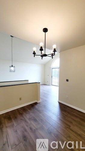A large empty room with a chandelier and a long counter.