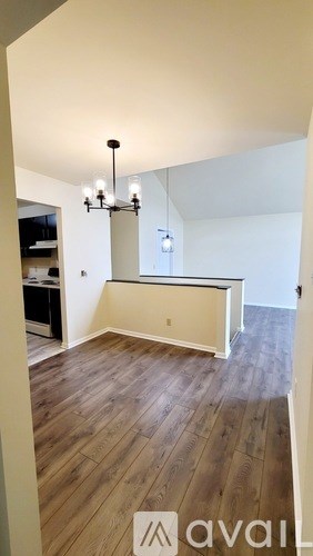 A room with wooden floors and a chandelier.