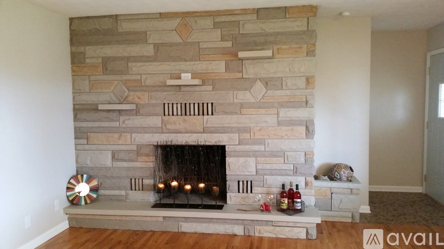 A stone fireplace with a fire burning in it.