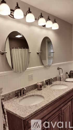 A bathroom with two sinks and two mirrors.
