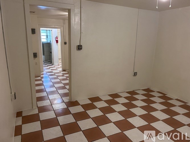A hallway with a checkered floor pattern.