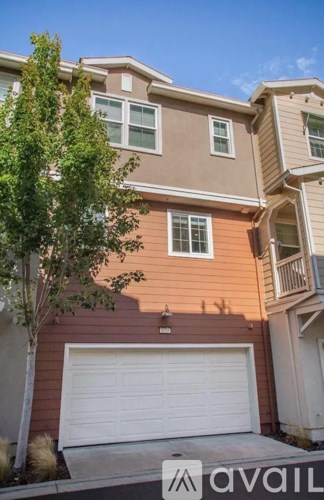 A two-story house with a white garage door.