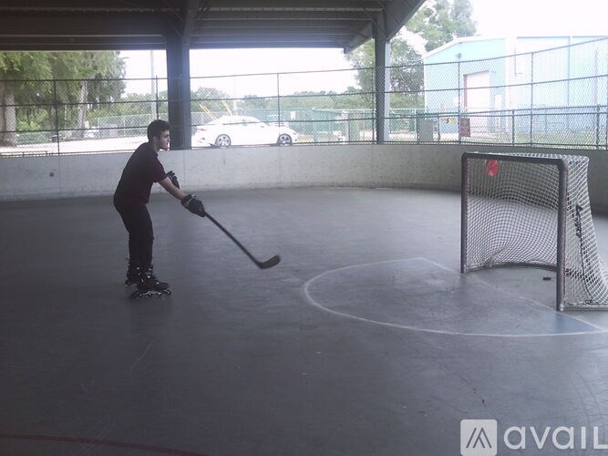 A man is playing golf in an indoor court.