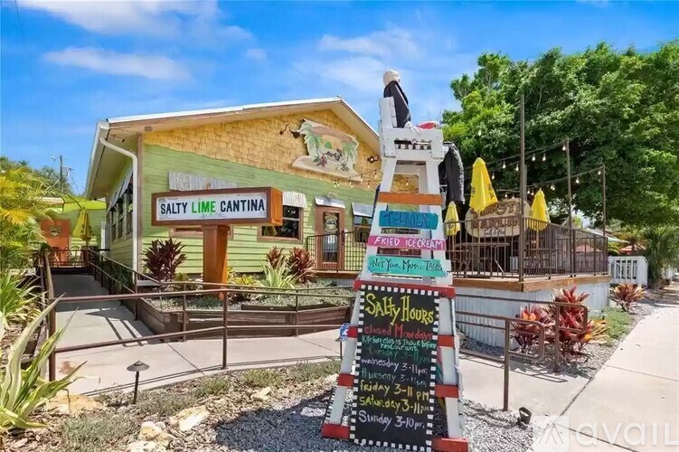 A restaurant named Salty Lime Cantina with a signboard in front.